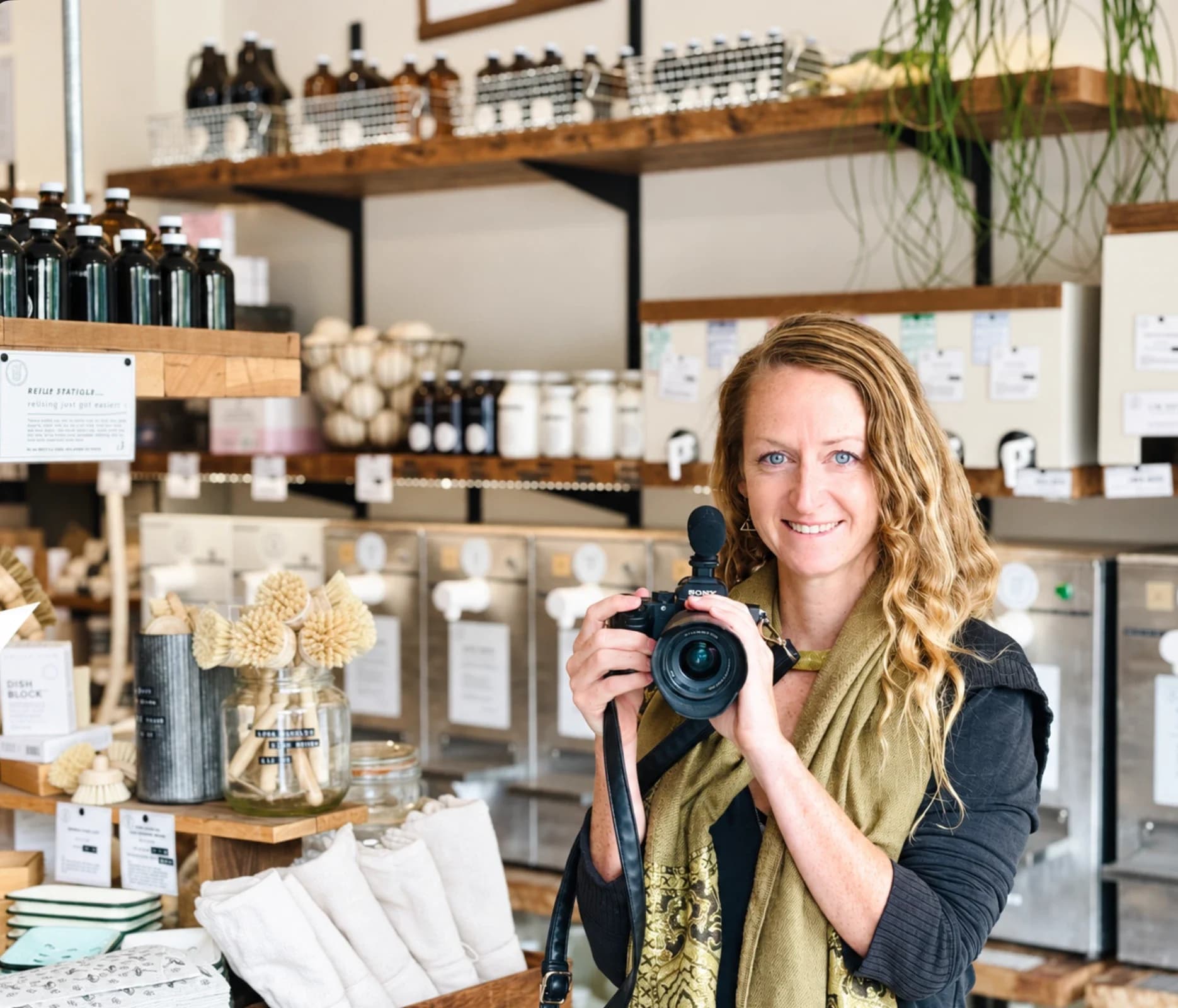 Glo Moss with her camera in a refill shop
